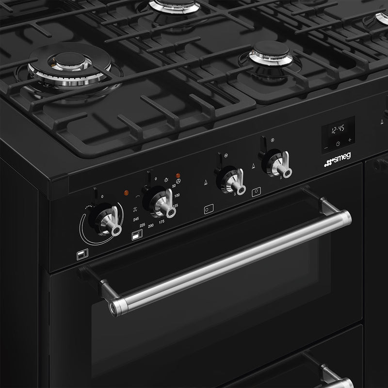 Black Smeg 100cm dual fuel range cooker with four gas burners, control knobs, and stainless steel handle, Free Delivery. - DB Domestics