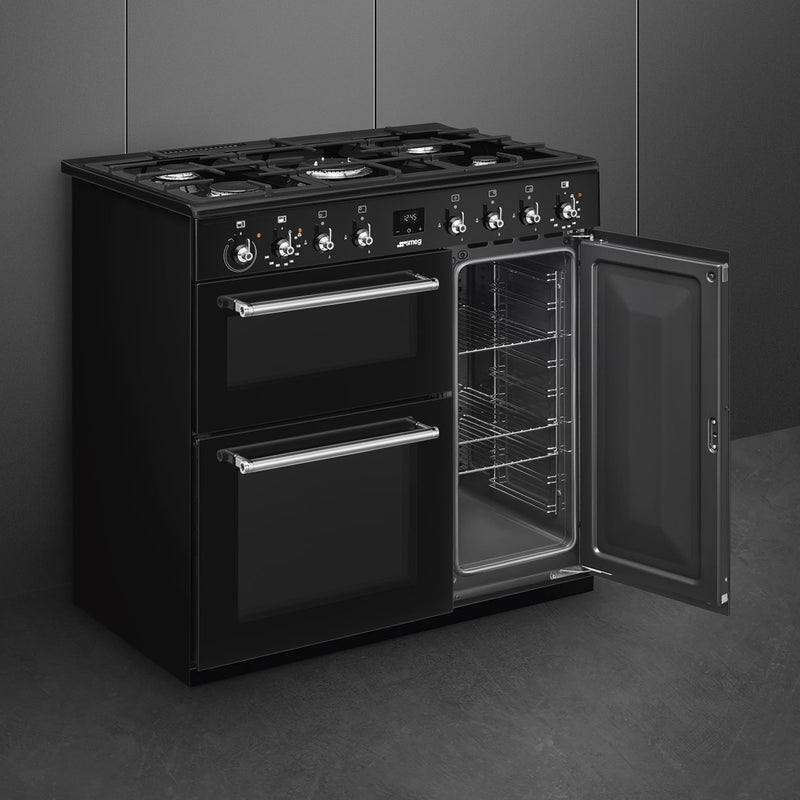 Black Smeg CX93GMBL 90cm dual fuel range cooker with open glass oven door, stainless steel handles, available in Eastbourne. - DB Domestics
