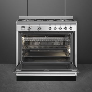 Stainless steel Smeg 90cm dual fuel range cooker with open oven door, six control knobs, Free Delivery Eastbourne Uckfield. - DB Domestics