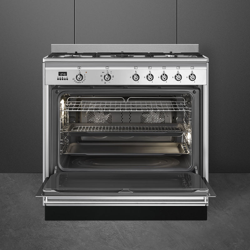 Stainless steel Smeg 90cm dual fuel range cooker with open oven door, six control knobs, Free Delivery Eastbourne Uckfield. - DB Domestics