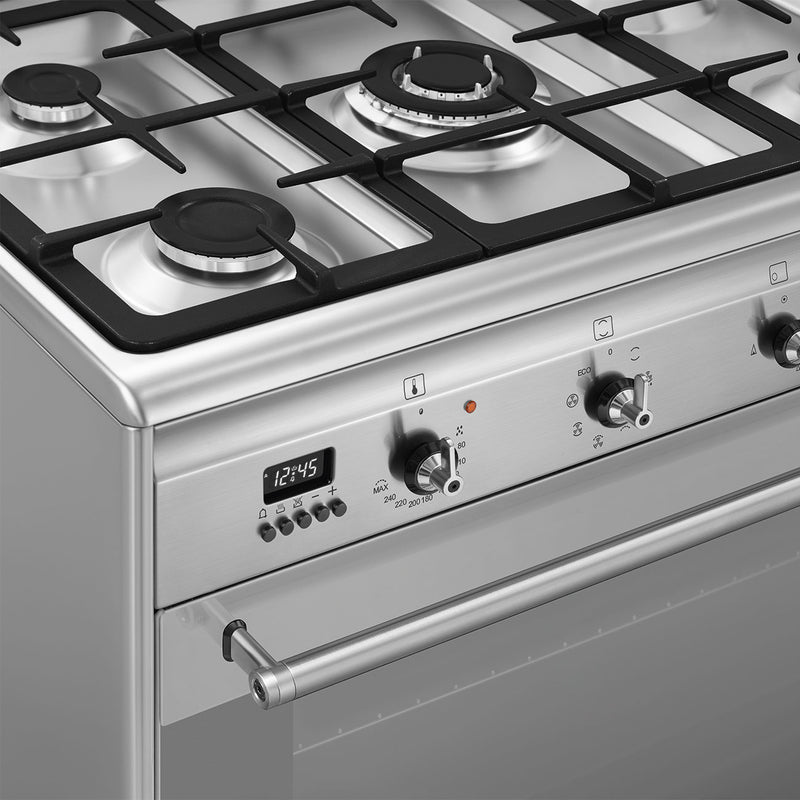 Smeg 90cm dual fuel range cooker in stainless steel with four gas burners and digital clock, available with Free Delivery in . - DB Domestics